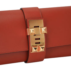 Medor 23 Clutch Bag Brique Tadelakt Leather with Gold Hardware
